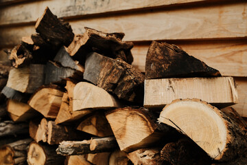 Neatly stacked firewood in rustic setting with natural wood textures and warm tones. Perfect for eco, energy, and rural lifestyle visuals