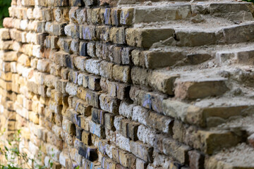 the destroyed ancient brick wall