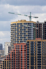 Urban High-Rise Construction with Tower Crane and Modern Apartments