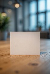 A vertical business card mockup placed on a textured wood surface with a blank design space, highlighted by soft ambient lighting. Generative AI