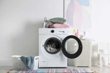Laundry room interior with washing machine, basket and detergents