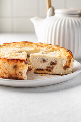 Homemade cottage cheese casserole pie with raisins. Baked cheesecake for healthy breakfast on white table background, text space