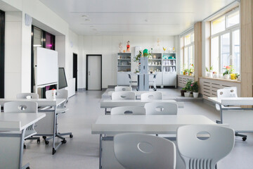 Bright Modern Classroom Interior with Desks, Chairs and Natural Light