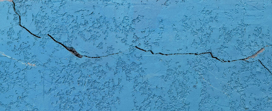 Blue painted wall. Abstract Cracked Surface Background &ndash; Broken Wall Destruction with Explosion and Debris Effect Illustration	
