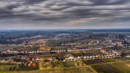 Aerial view of a wine village in winter light
Traditional wine cellars line the hills of a Hungarian village under dramatic winte