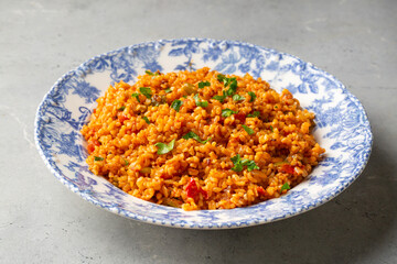Traditional turkish bulgur pilaf with tomato sause in plate (Turkish name; meyhane pilavi)