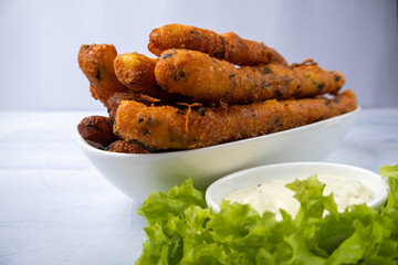 Potato dough sticks fried in oil. Served with a lettuce leaf and sauce