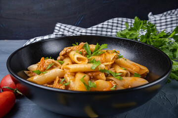 Penne pasta with meat and seasonings on a plate