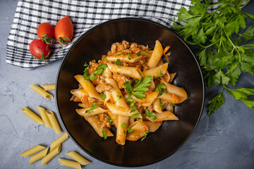 Penne pasta with meat and seasonings on a plate