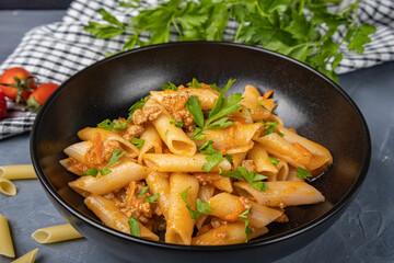 Penne pasta with meat and seasonings on a plate