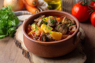 Beef goulash, soup and a stew, made of beef chuck steak, potatoes and plenty of paprika. Hungarian  traditional meal.