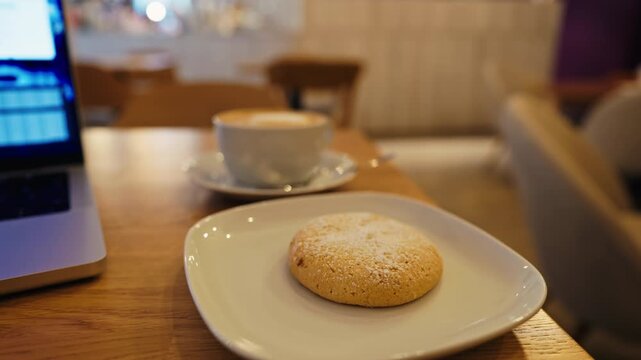 Crips cookie on white plate with warm coffee ambiance, Quiet scene of cookie and coffee on wooden