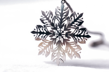 Silver snowflake pendant delicate winter jewelry isolated on white background