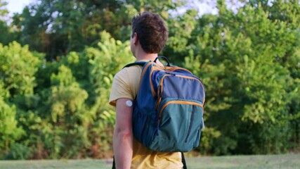 Man with diabetes goes for a walk in a beautiful park while simultaneously monitoring his glucose levels with a smart device with ease.