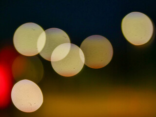 Colorful bokeh background for design. The circles are of varying sizes and are scattered throughout the photo. Scene is one of chaos and disorder