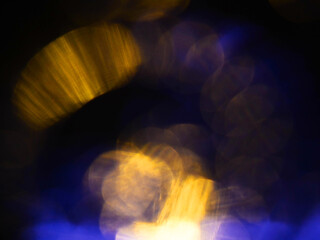 Abstract bokeh scene. Golden and blue glowing light leaks on black color background for design. Light effect.