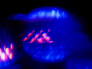 Abstract colorful light leaks on black background for design or special effects. Random shapes and dominant blue color.