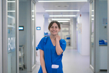 Obraz premium Smiling female nurse working in hospital corridor healthcare