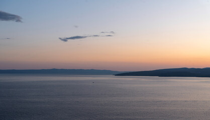 Sunset sea with headland and boat