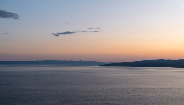 Sunset sea with headland and boat