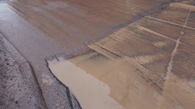 Surface features of resurfaced tarmac, Visual analysis of tarmac patch with water and mud deposits