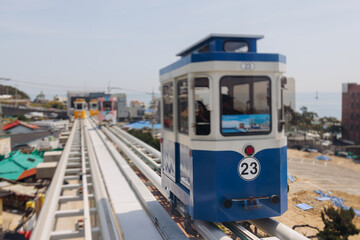 Naklejka premium Haeundae Blue Line Park, Busan, ride on multicoloured sky capsule train, railway tram route from Mipo to Cheongsapo station, coastal monorail in Busan, Yeongnam, South Korea, Republic of Korea travel