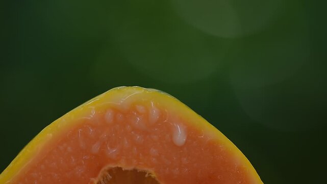 Papaya latex or papain on fruit and on natural background.