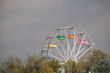 Section of a colorful ferris wheel in the amusement park.