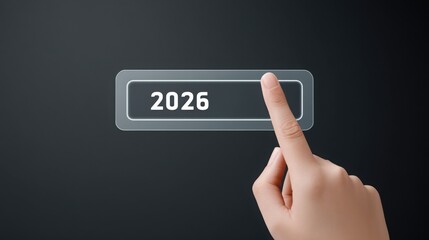 tech goal 2026 A hand touching a digital button displaying the year 2026 against a dark background.