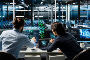 System administrators coding in data center, updating AI driven automation scripts. IT experts working in server room, programming artificial intelligence algorithms, debugging equipment