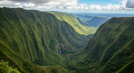 Naklejka premium Lush Green Valley with Waterfall