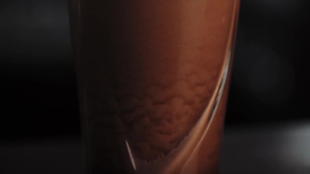 NIZHNY NOVGOROOD, RUSSIA, June 21, 2016 - Pint of Guinness beer on the table, the foam slowly settles. Bar background. High quality 4k footage