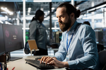 Frowning programmer in server room worried after reading diagnostic report showing critical...