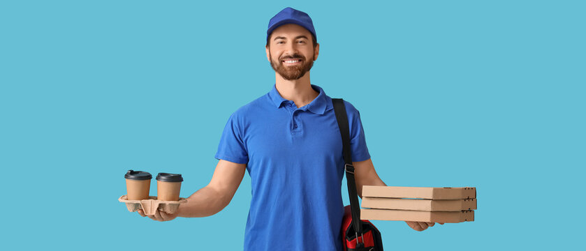 Male courier with pizza boxes and coffee cups on blue background
