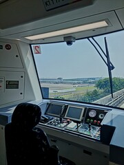 Train driver cabin with control panels and forward track view