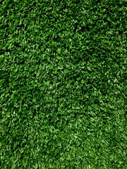 Close-up texture of short artificial grass showing detailed fibers and realistic green color
