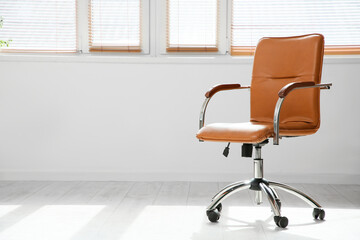 Office brown chair near window in room, closeup