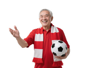 An elderly man in red shirt with scarf holds soccer ball and gestures, showing enthusiasm for sports.