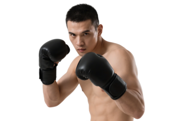 A young male boxer in black gloves is in a fighting stance, demonstrating athleticism and readiness for combat.