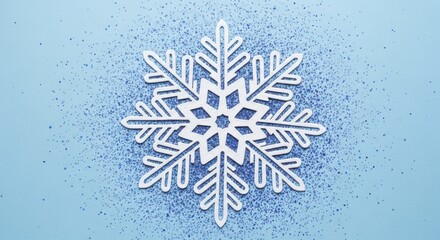 White decorative snowflake against light blue background with scattered shimmering glitter for winter holidays