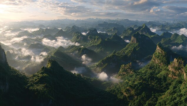 Lush, mountainous landscape unfolds, veiled in clouds and sunlight, showcasing a dramatic vista of towering peaks and dense forests.