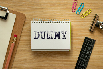 There is notebook with the word DUMMY. It is as an eye-catching image.
