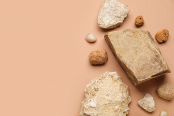 Composition with different decorative stones on brown background, closeup
