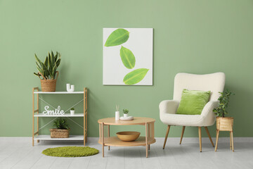 Coffee table, armchair and shelving unit near green wall in interior of living room