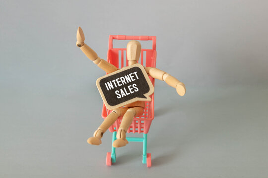 A grocery cart, a person, and an internet sales sign - Powered by Adobe