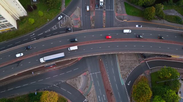 Top-down aerial view of Mancunian Way crossing over Stockport Road in Manchester at dawn.