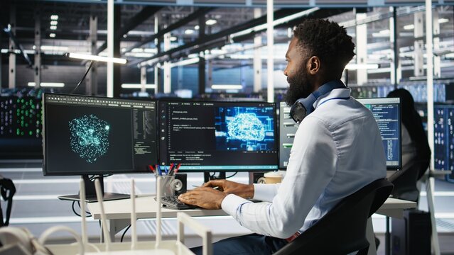 Data center system administrator using AI neural network models to configure hardware. Employee works on machine learning programming language in server room, optimizing system functionality, camera A - Powered by Adobe