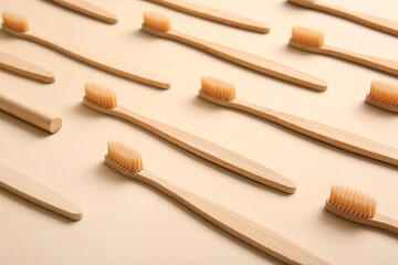 Composition with wooden toothbrushes on beige background, closeup