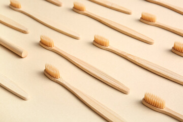 Composition with wooden toothbrushes on beige background, closeup