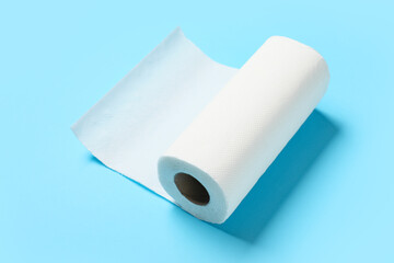 Roll of paper towels on blue background